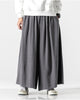 Dark gray extra-wide linen-cotton skirt pants worn with a white sweatshirt and white sneakers