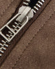 Close-up of the large metal zip pull on the faux suede