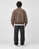 Model wearing the brown faux suede bomber, back view