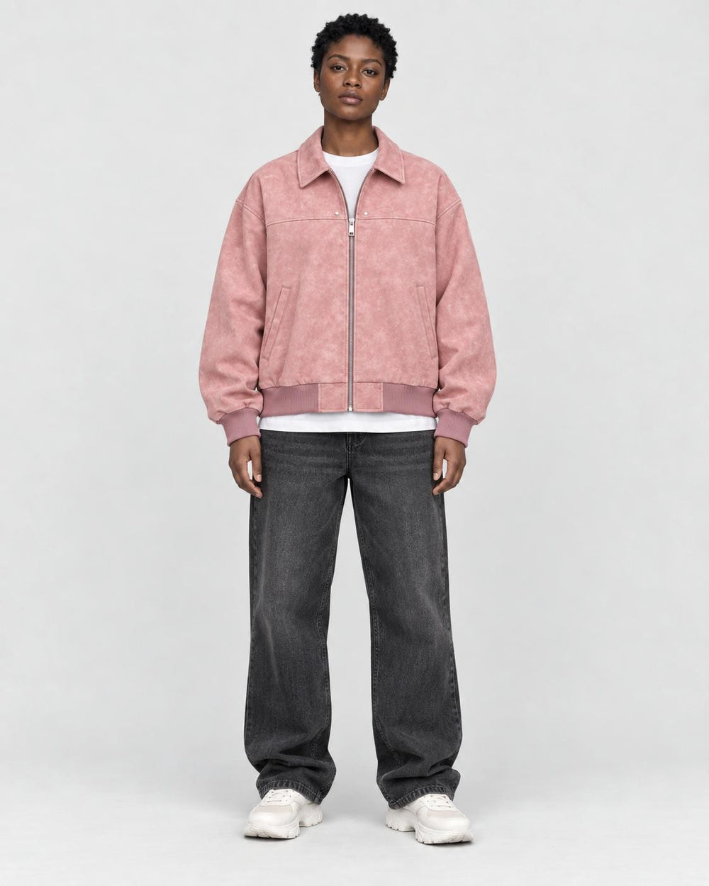 Model wearing the pink faux suede bomber, front view