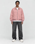 Model wearing the pink faux suede bomber, front view