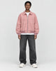 Model wearing the pink faux suede bomber, front view