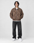 Model wearing the brown faux suede bomber over a white tee, front view