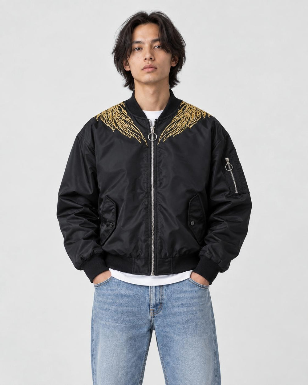 Model wearing the black bomber jacket zipped up over a white tee, front view