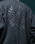 Close-up of the circular CREATE THE FUTURE, EH, MIRACULOUS print on the back of the dark jacket
