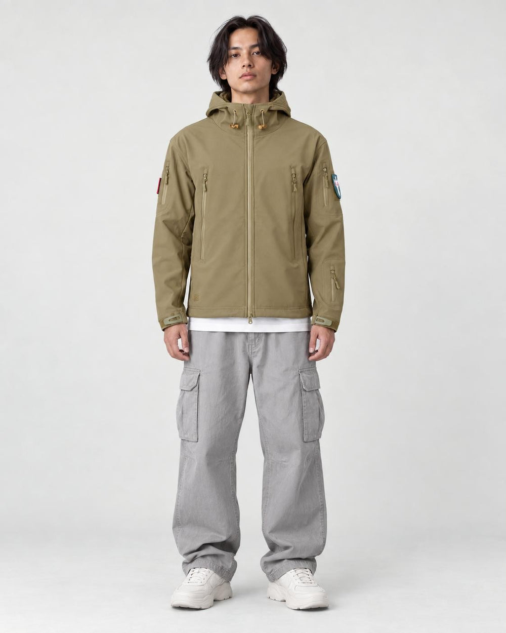 Model wearing the khaki softshell hooded jacket, front view