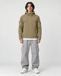 Model wearing the khaki softshell hooded jacket, front view