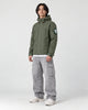 Model wearing the army green softshell jacket, three-quarter view