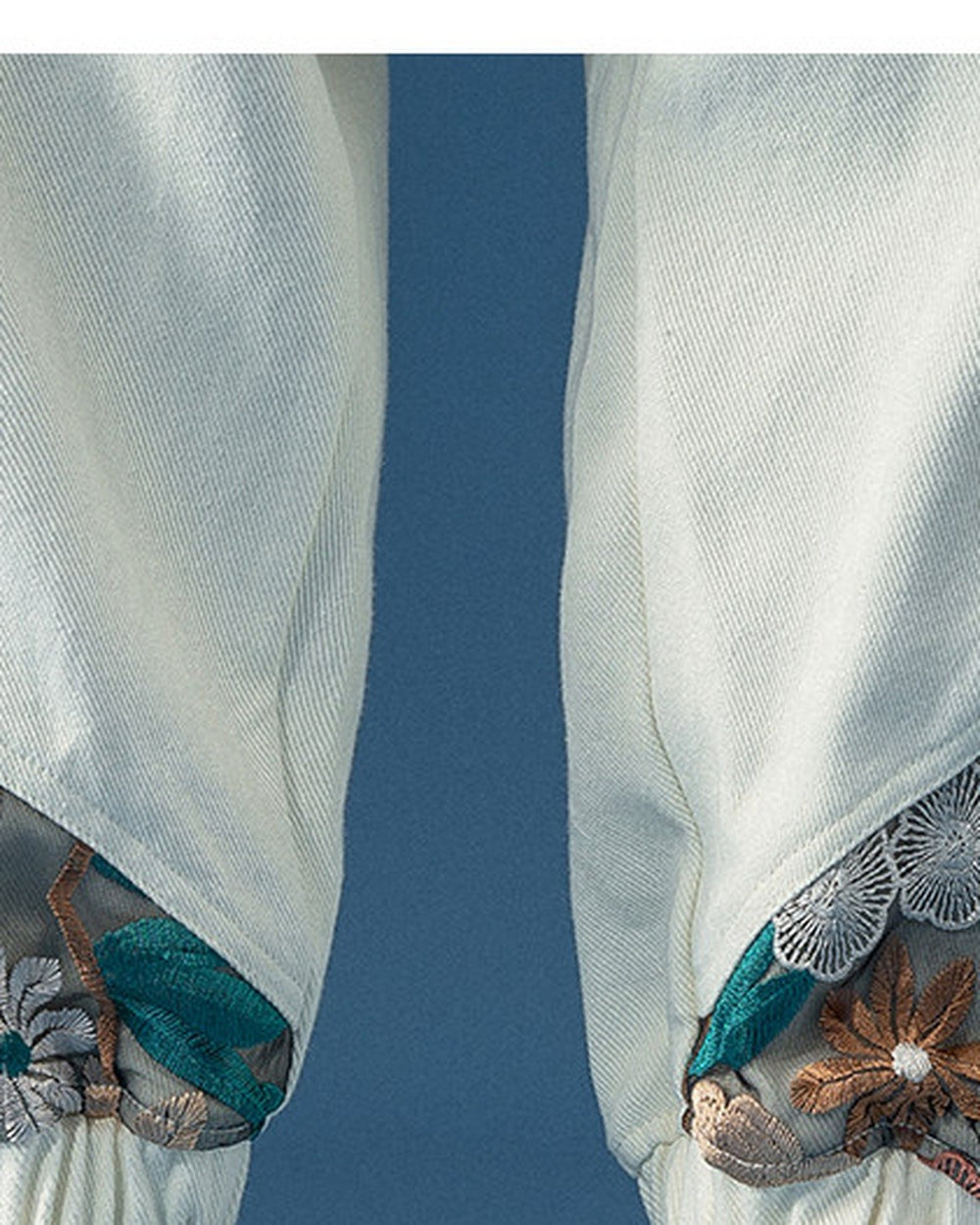 Close-up of the embroidered panels meeting the elastic ankle cuffs
