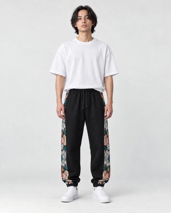 Model wearing the black floral embroidered jogger pants, front view