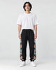 Model wearing the black floral embroidered jogger pants, front view