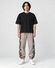 Model wearing the dusty pink floral embroidered jogger pants, front view