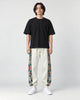 Model wearing the off-white floral embroidered jogger pants, front view