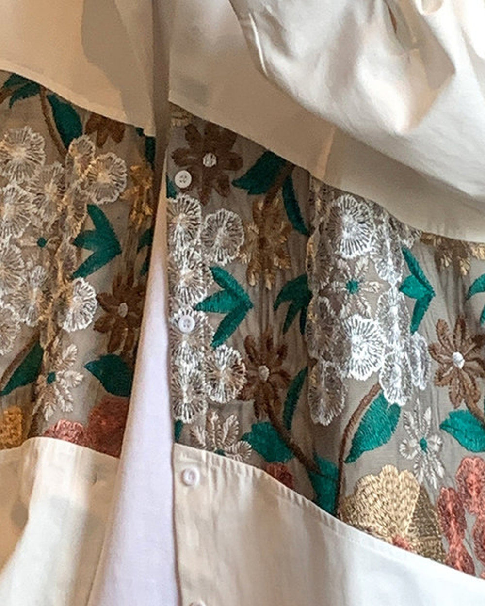 Close-up of the floral tapestry band on the white shirt jacket