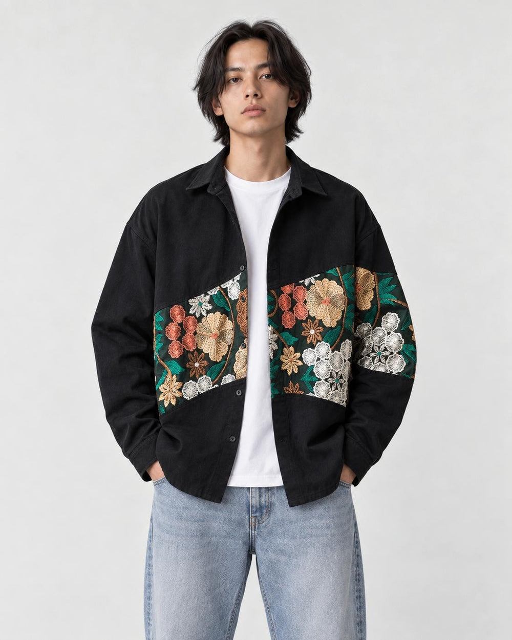 Model wearing the black floral tapestry patchwork shirt jacket open over a white tee, front view