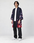 Model wearing the navy haori with cherry blossoms and dark jeans, three-quarter view