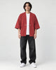 Model wearing the red haori jacket over a white tee, front view