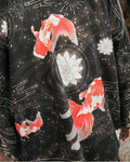 Close-up of the red-and-white goldfish, white lotus discs and gold fireworks printed on the black haori