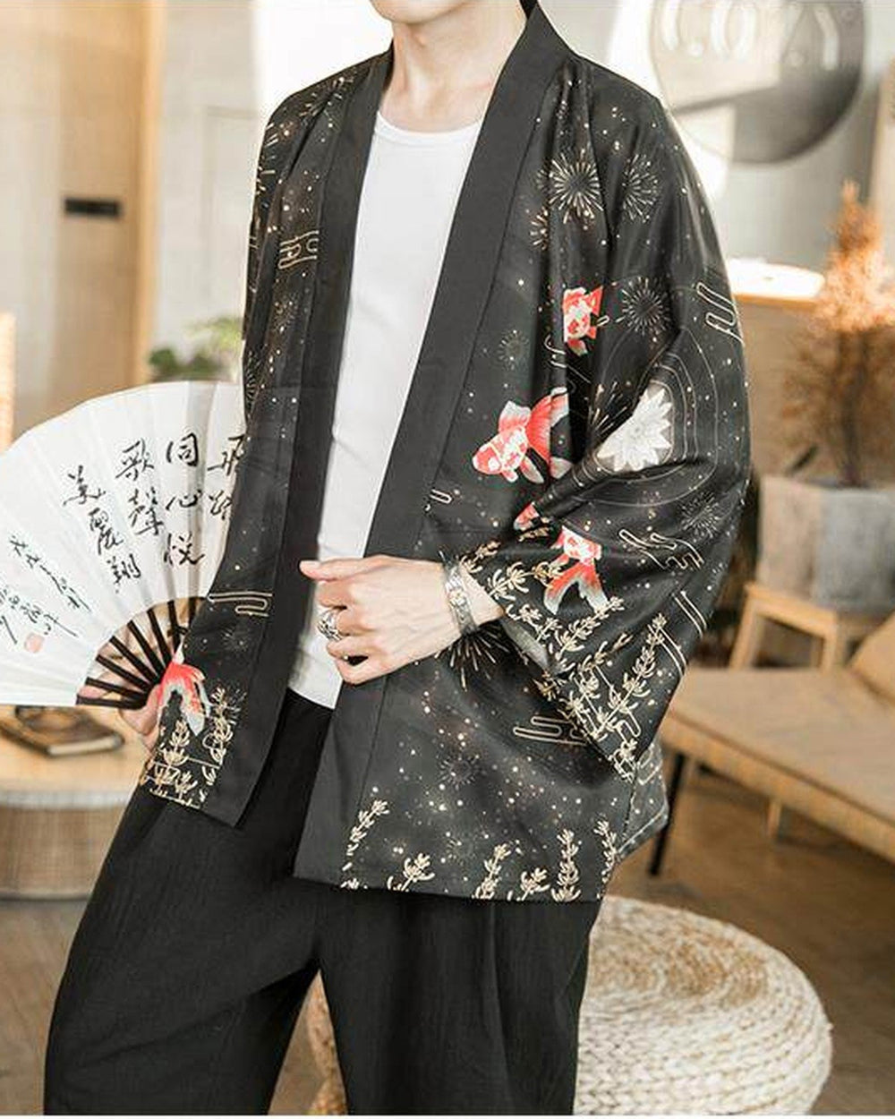 Black haori cardigan worn open over a white tee, with goldfish and gold sprigs on the fronts and sleeves