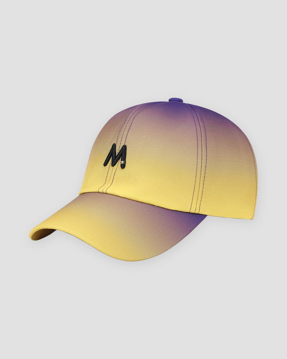 Baseball cap fading from purple at the crown to yellow at the brim, with a black M on the front