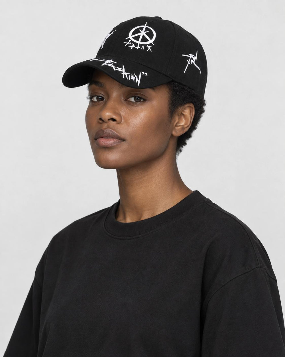 Model wearing the black graffiti cap, three-quarter view