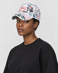 Model wearing the white graffiti print cap, three-quarter view