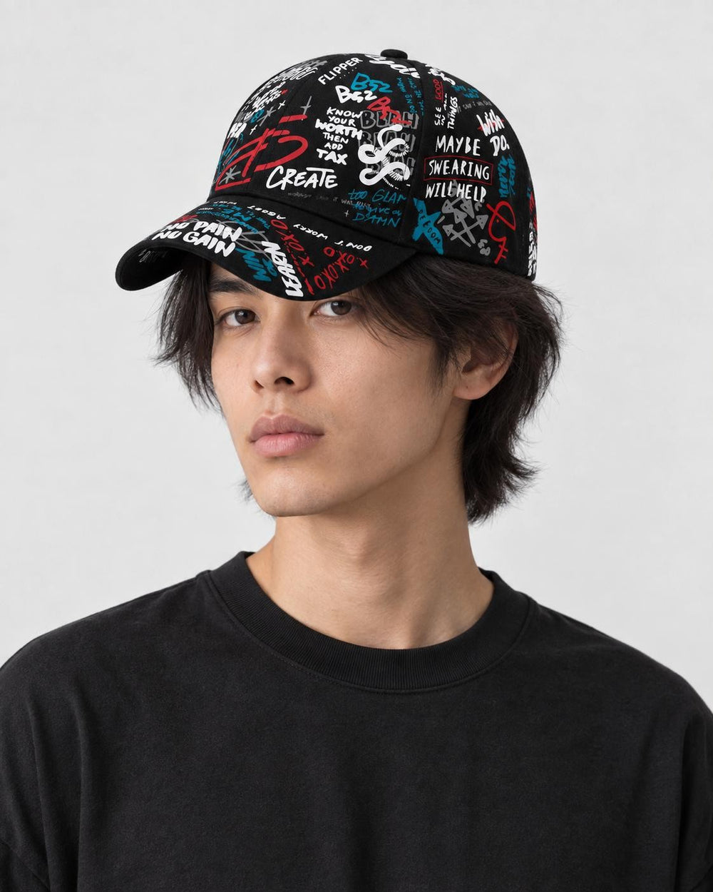 Model wearing the black graffiti print cap, three-quarter view