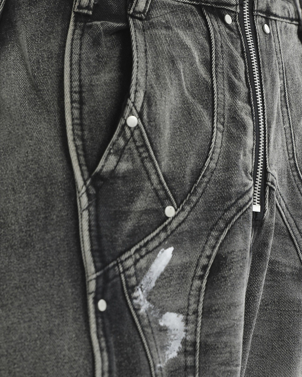 Close-up of the curved raised seams, rivets and white paint marks