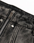 Close-up of the waistband, exposed zip fly and washed denim