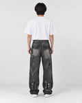 Model wearing the graffiti jeans, back view with flap pockets and painted letters