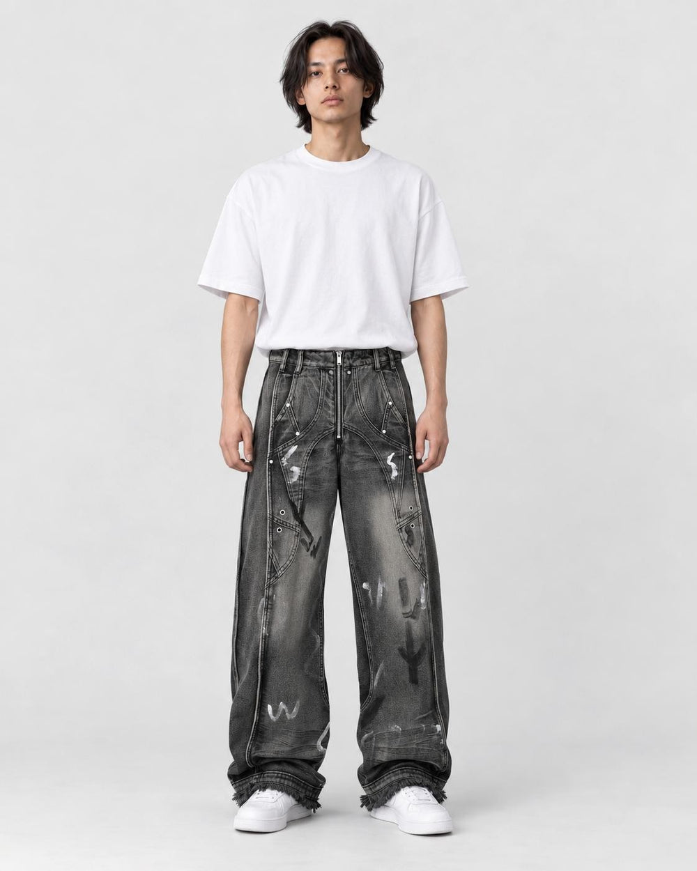Model wearing the graffiti wash wide-leg jeans with a white tee, front view
