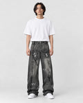 Model wearing the graffiti wash wide-leg jeans with a white tee, front view