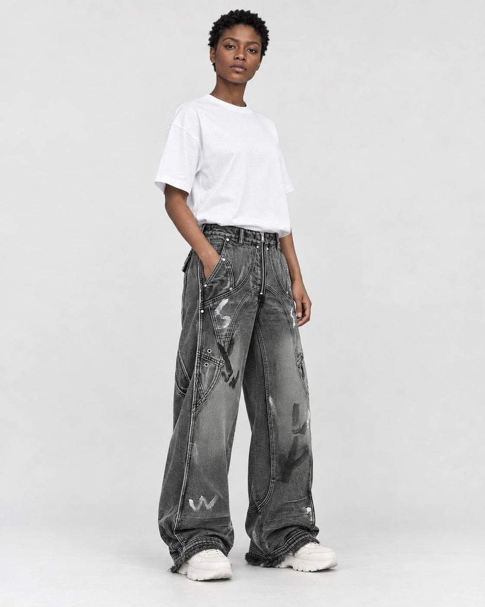 Model wearing the washed black graffiti jeans, three-quarter view