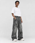 Model wearing the washed black graffiti jeans, three-quarter view