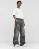 Model wearing the washed black graffiti jeans, three-quarter view