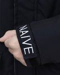 Close-up of the hook-and-loop cuff lettered NAIVE on the black puffer jacket