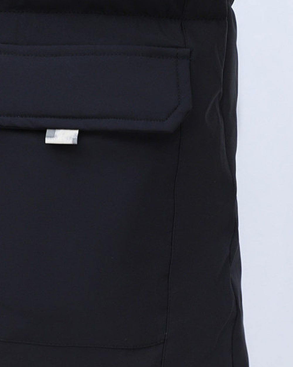 Close-up of the flap pocket on the black puffer jacket