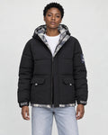 Model wearing the black puffer jacket with camouflage lining over a white tee, front view