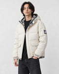 Model wearing the cream puffer jacket with camouflage lining, three-quarter view