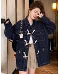 Dark indigo horn toggle denim jacket with cream toggles, flap pockets and metal buttons, worn with a beige skirt