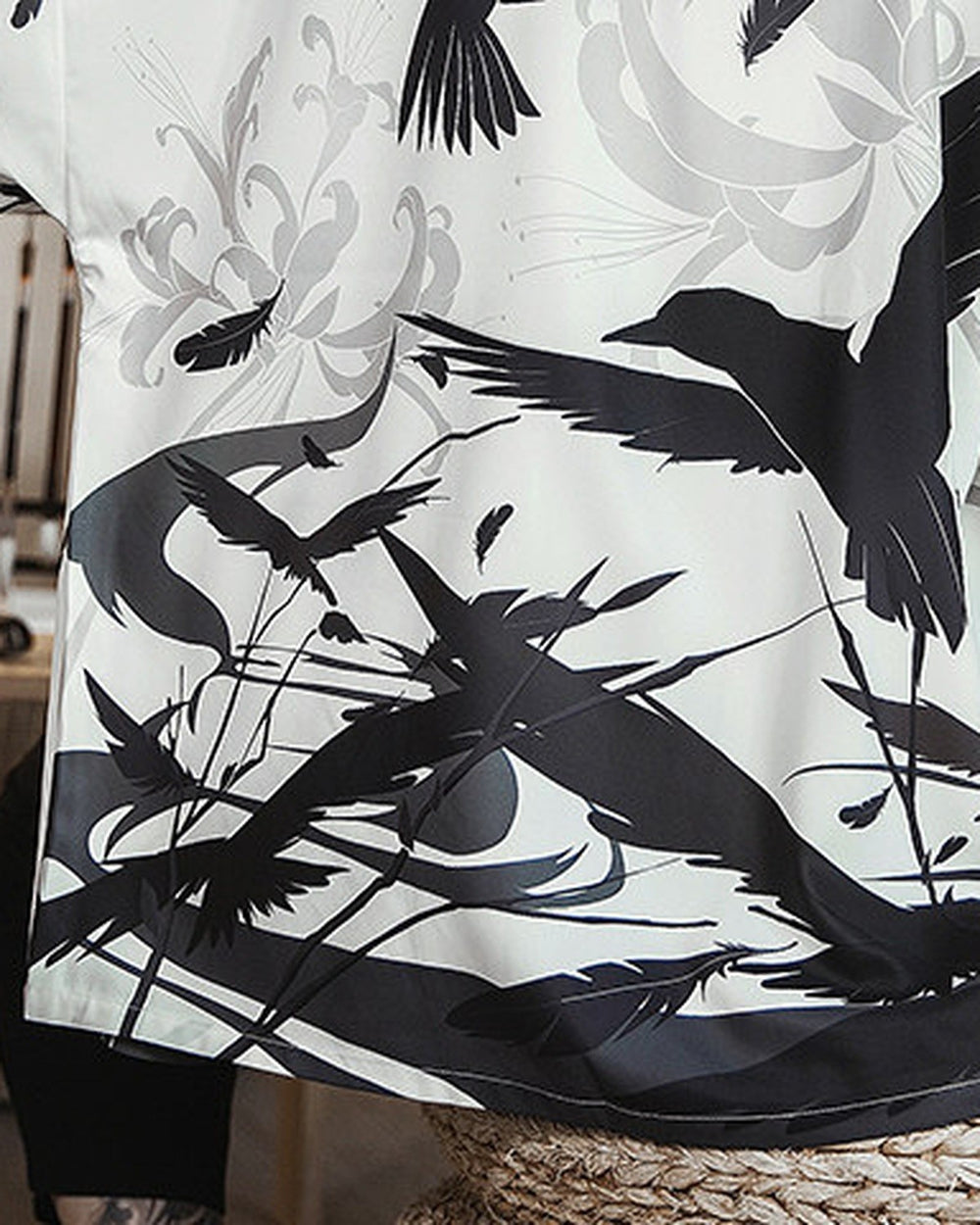 Close-up of the black ink-wash birds, gray spider lilies and reeds printed on the haori