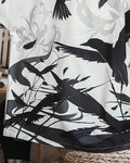 Close-up of the black ink-wash birds, gray spider lilies and reeds printed on the haori