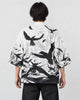 Model wearing the white haori cardigan with black ink-wash birds printed across the back, back view