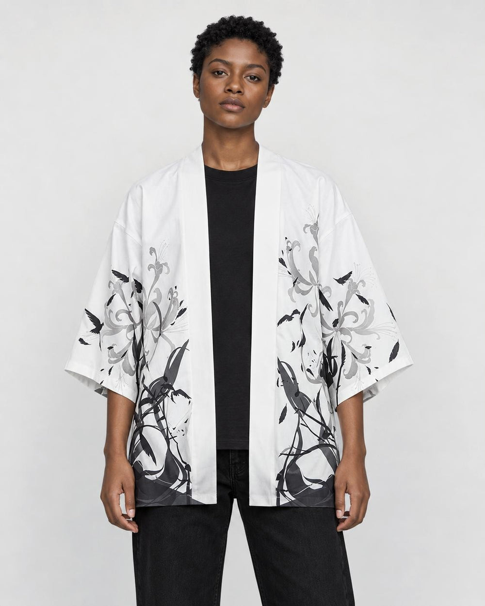 Model wearing the white haori cardigan open over a black tee, front view
