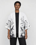 Model wearing the white haori cardigan open over a black tee, front view