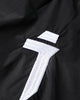 Close-up of the embroidered white logo on the front thigh