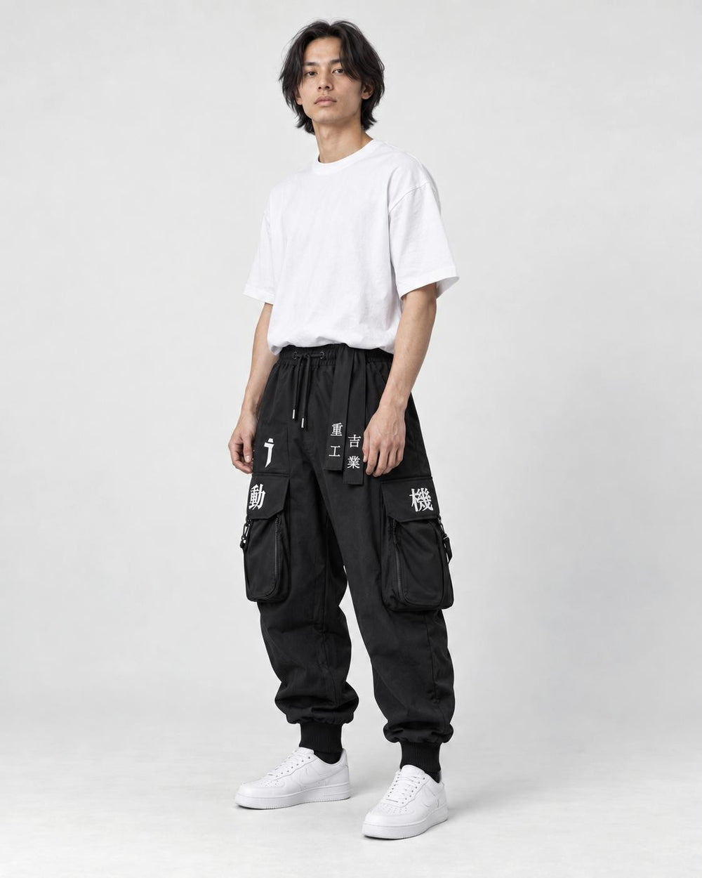 Model wearing the black techwear cargo joggers, three-quarter view