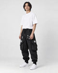 Model wearing the black techwear cargo joggers, three-quarter view