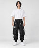 Model wearing the black kanji techwear cargo joggers with a white tee, front view