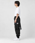 Model wearing the black cargo joggers, side view of the lettered hip straps